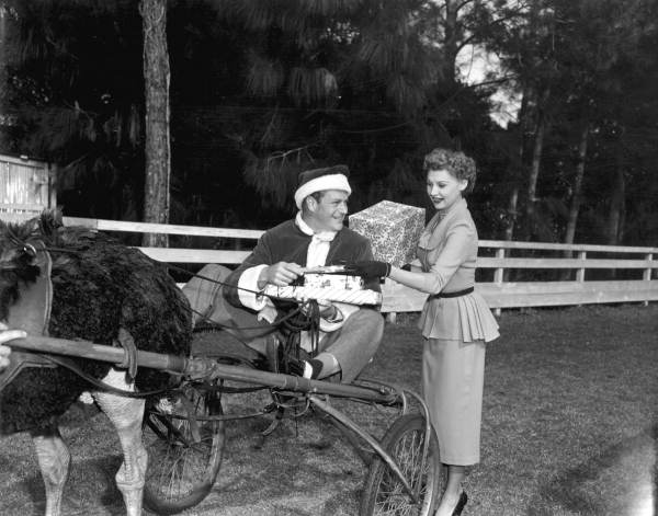 Richard Webb on an ostrich-drawn cart and Mari Aldon hold gifts during "Distant Drums" premiere - Saint Augustine, Florida