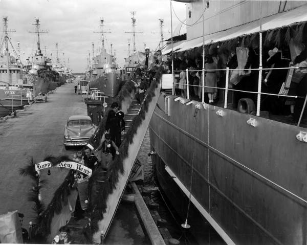 Sailors and families leaving a ship for the "Distant Drums" premiere in Saint Augustine, Florida.