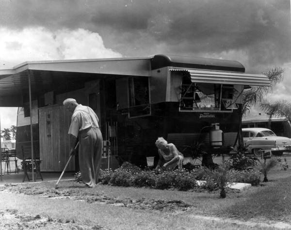 Unidentified couple tends to their yard at Trailer Estates - Sarasota, Florida 