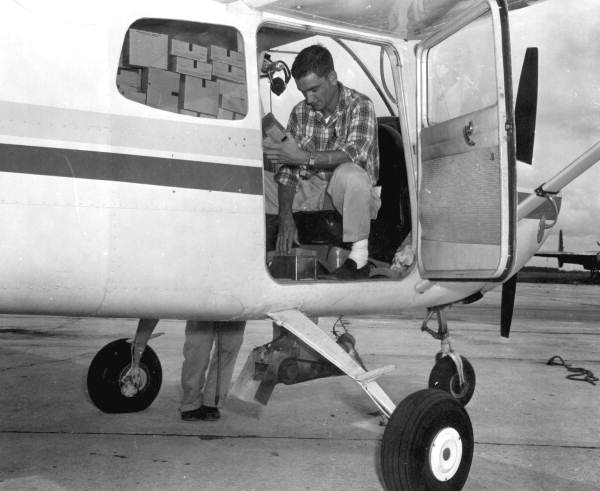 Pilot prepares boxes of sterile screwworm pupae to be dropped on a cattle ranch - Sebring, Florida