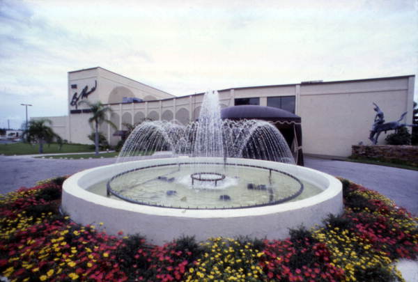 View showing water fountain with the Burt Reynolds Dinner Theatre in background - Jupiter, Florida.