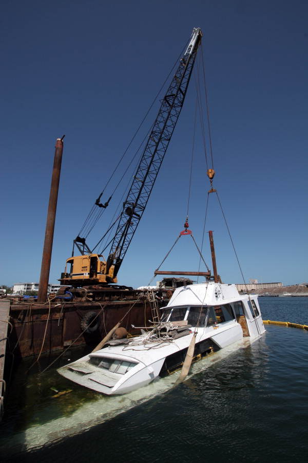 Sunk yacht being retrieved by crane from Garrison Bight Marina - Key West, Florida