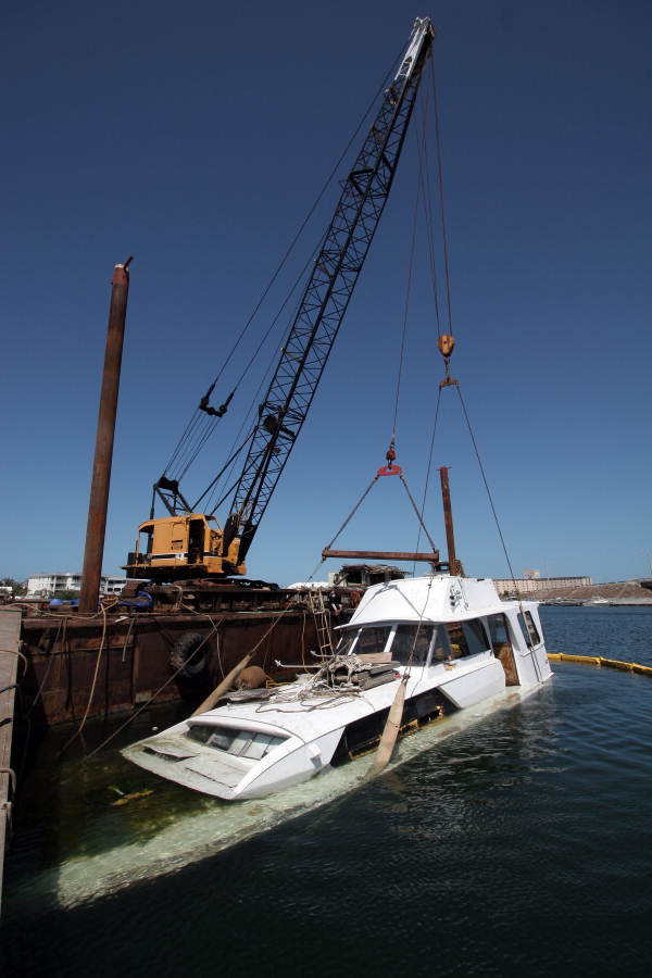 Sunken yacht being retrieved by crane from Garrison Bight Marina - Key West, Florida