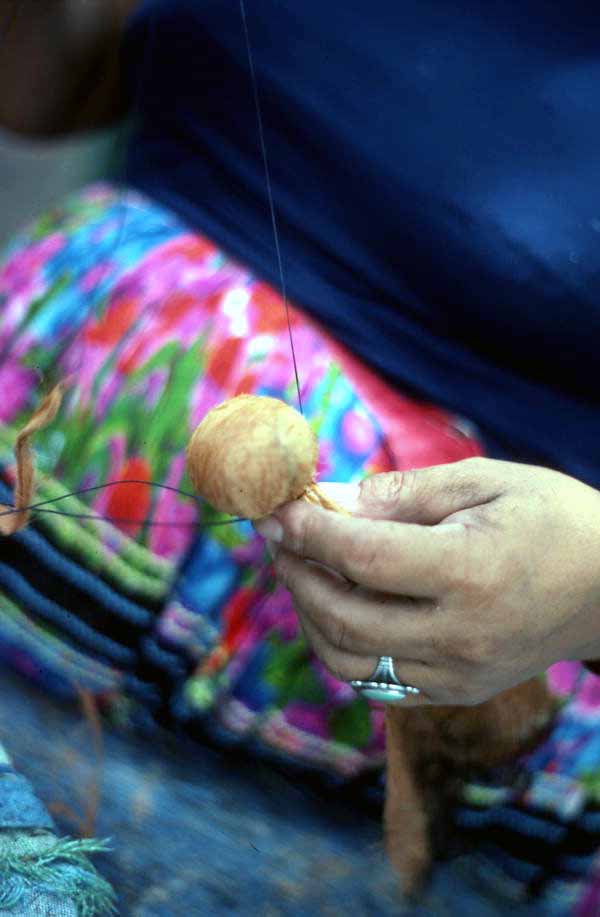 Mary B. Billie sewing a Seminole doll head to the body - Big Cypress Reservation, Florida