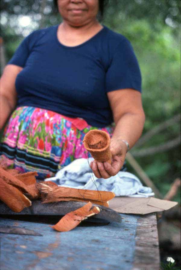 Mary Billie displaying work after stuffing Seminole doll with palmetto fibers - Big Cypress Reservation, Florida