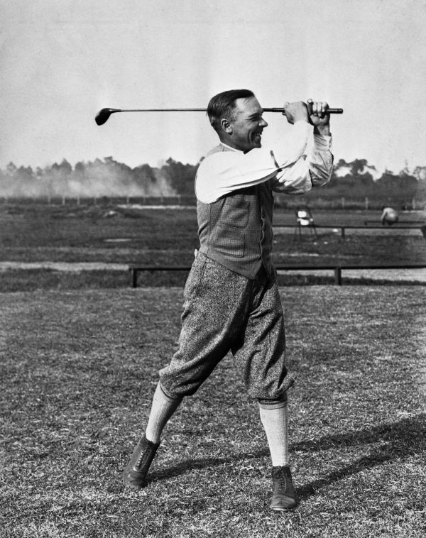 Race car driver Sig Haugdahl with clubs he had specially made