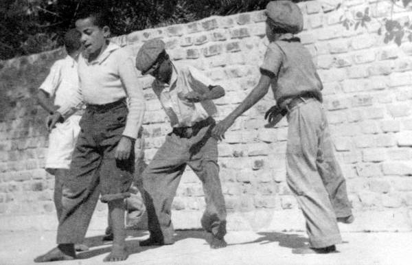 Four boys dancing in front of the Hemingway residence in Key West