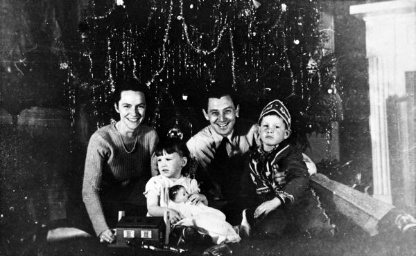 LeRoy Collins and his family in front of a Christmas tree