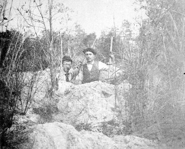 Two men at an Indian mound