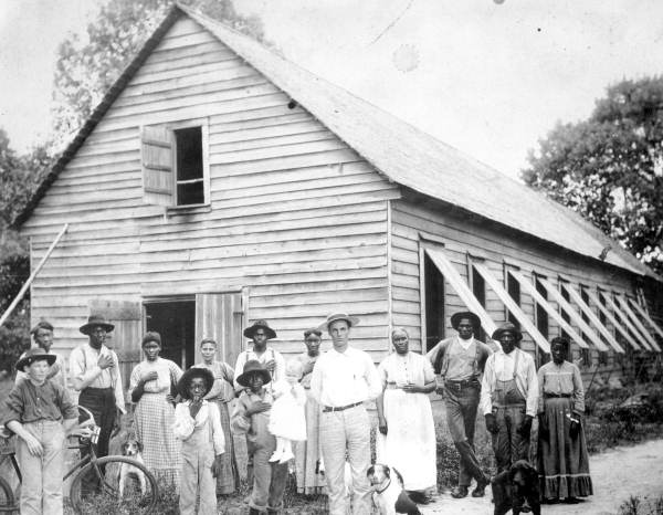 Magnus Delacy Peavy and his farm hands in front of a tobacco barn - Havana, Florida