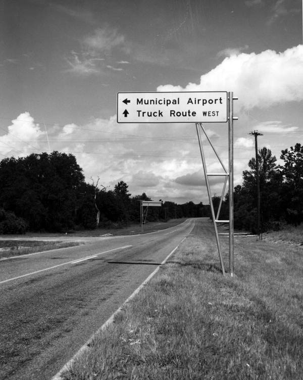 Direction sign along a road .