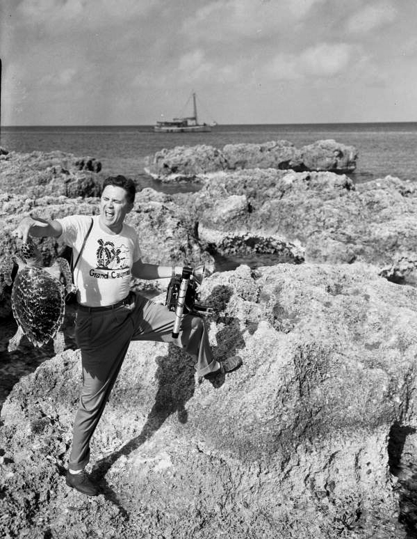 Sarasota photographer Joe Steinmetz at George Town in the Cayman Islands having his finger snapped by a turtle.