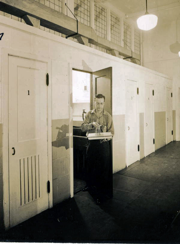 View showing a Naval Photography School student at the door to one of the darkrooms at NAS Pensacola.