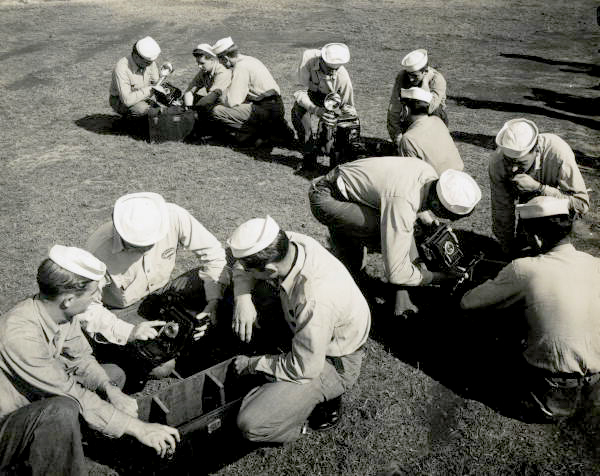 Naval Photography School instructors showing 4x5 cameras to students at NAS Pensacola.