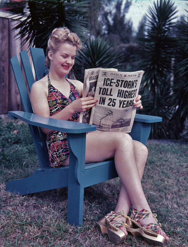Unidentified woman in Sarasota reading the March 5, 1940 edition of the Daily News paper story about winter storms up north.
