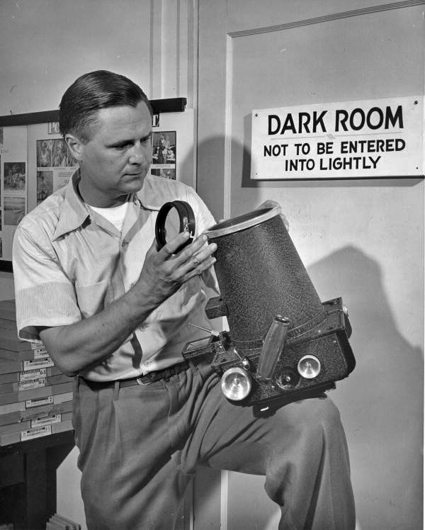 Joe Steinmetz with an F-8 Fairchild aerial camera at the entrance to the darkroom at his studio in Sarasota, Florida.