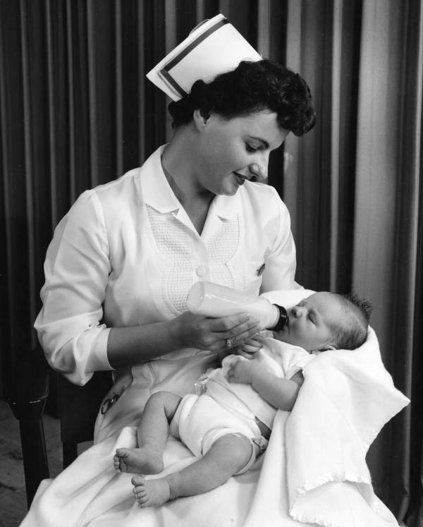 Nurse feeding an infant at the Sarasota Memorial Hospital for a publicity photo.