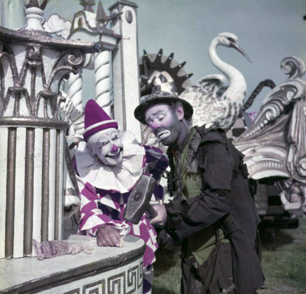 Ringling Circus clowns Charlie Bell, left, and Emmett Kelly cracking a peanut with a sledgehammer in Sarasota, Florida.