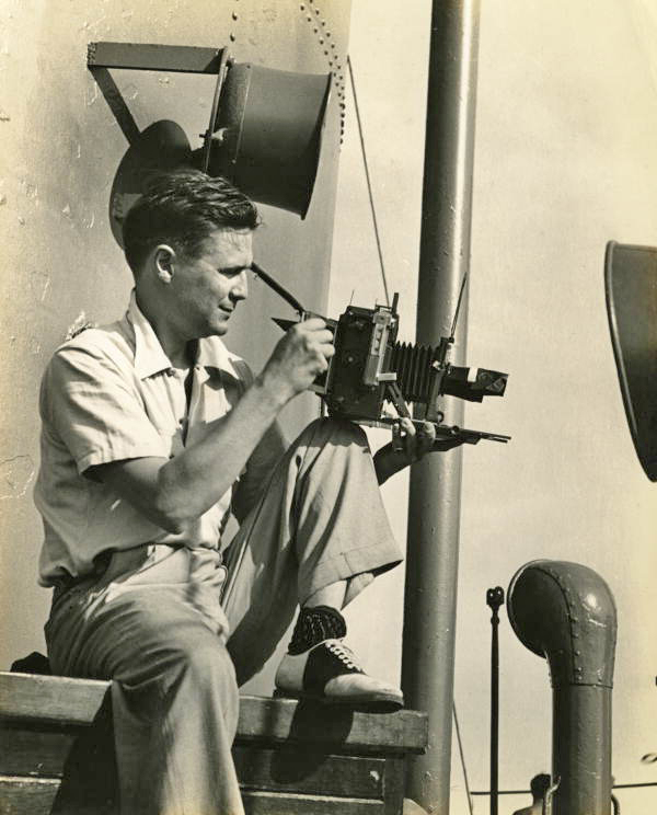Photographer Joe Steinmetz taking a photograph on board a ship traveling to Guatemala.