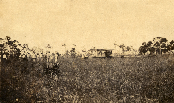 Crowd viewing an airplane.