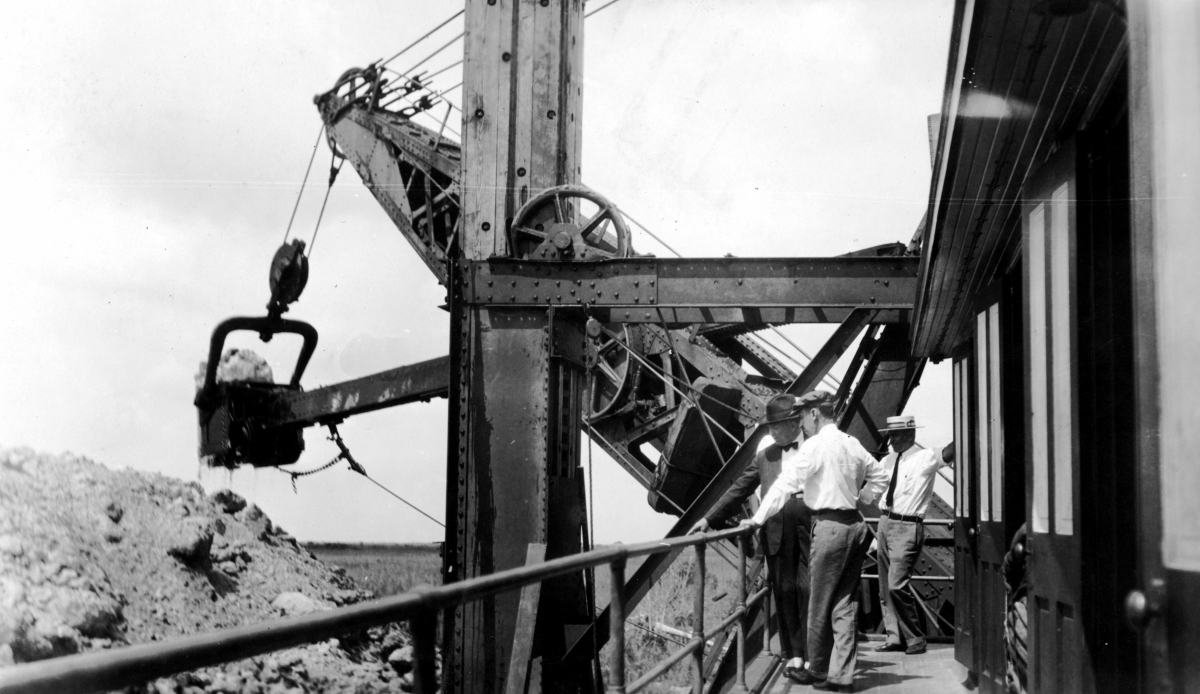 Chief drainage engineer Fred C. Elliot with men observing Caloosahatchee power shovel in action.