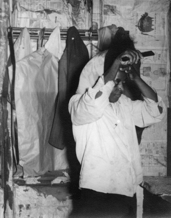 Woman at home combing her hair.