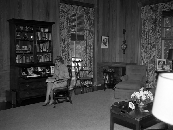 First Lady of Florida Mary Call Darby Collins viewing scrapbook at the Mansion in Tallahassee.