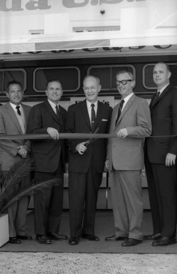 Governor Farris Bryant cutting the ribbon during an opening ceremony.