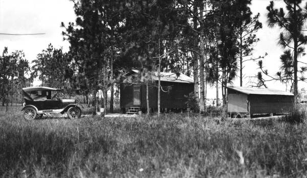 Car outside a shack.