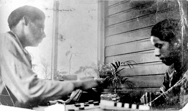 Tommie Buster and Henry Jumper playing checkers at the mission