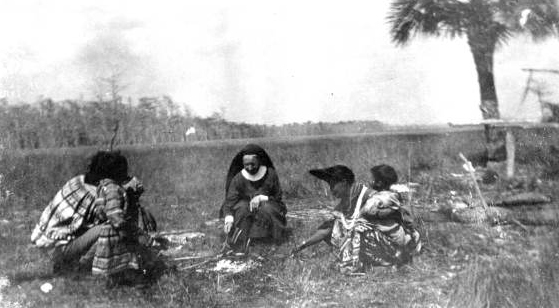 Deaconess Bedell and Seminole Indians roasting wieners