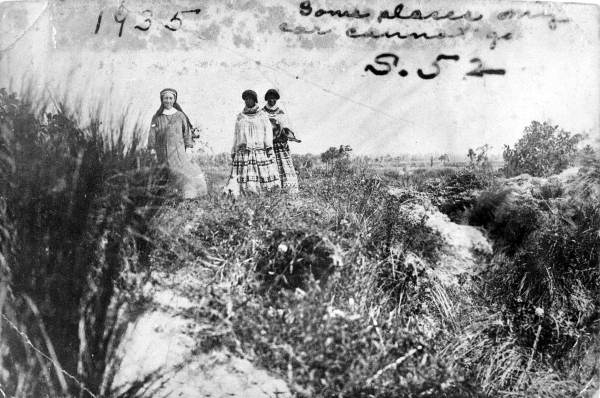 Deaconess Bedell and a Mikasuki woman walking in the Everglades