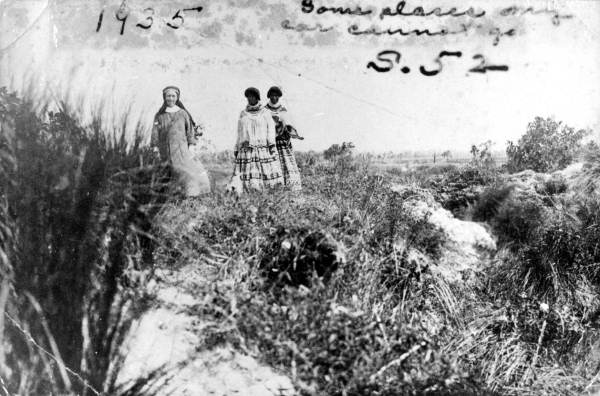 Deaconess Bedell and a Mikasuki woman walking in the Everglades