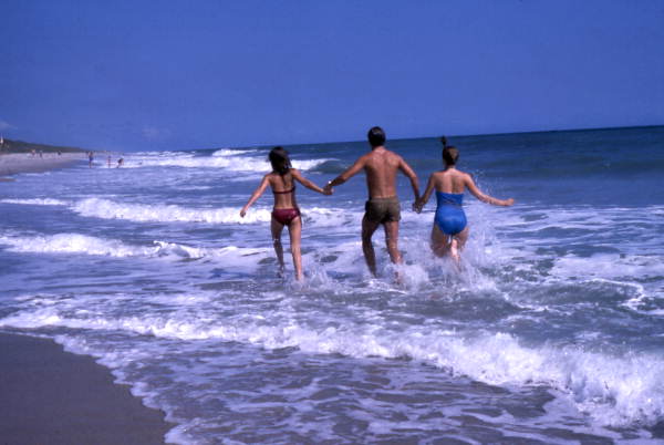 People running in the surf at the Canaveral National Seashore beach in Brevard County near Titusville, Florida.