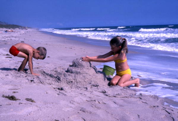 Children building a sandcastle at the Canaveral National Seashore beach in Brevard County near Titusville, Florida.