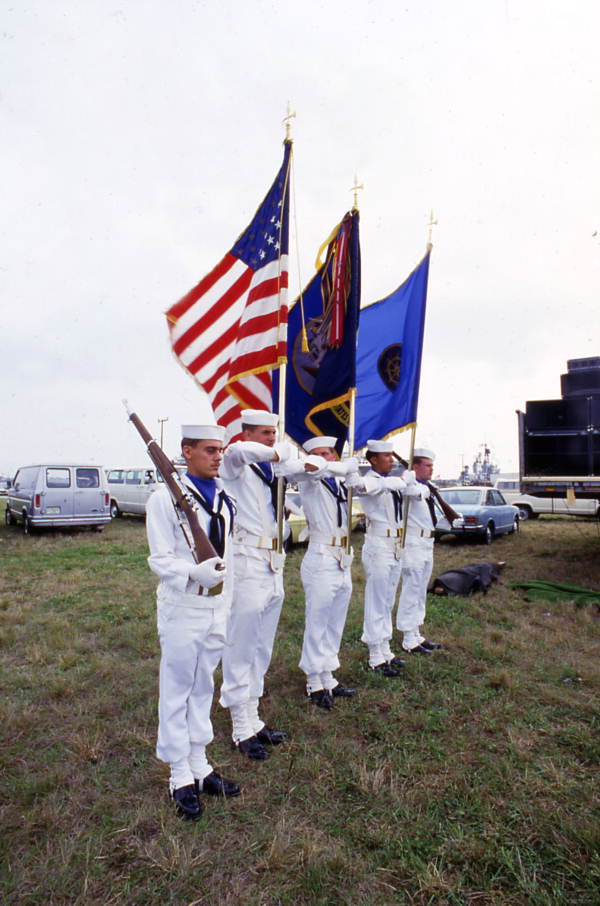 U.S. Naval sailors holding flags at the SeaFest seafood festival in Port Canaveral, Florida.