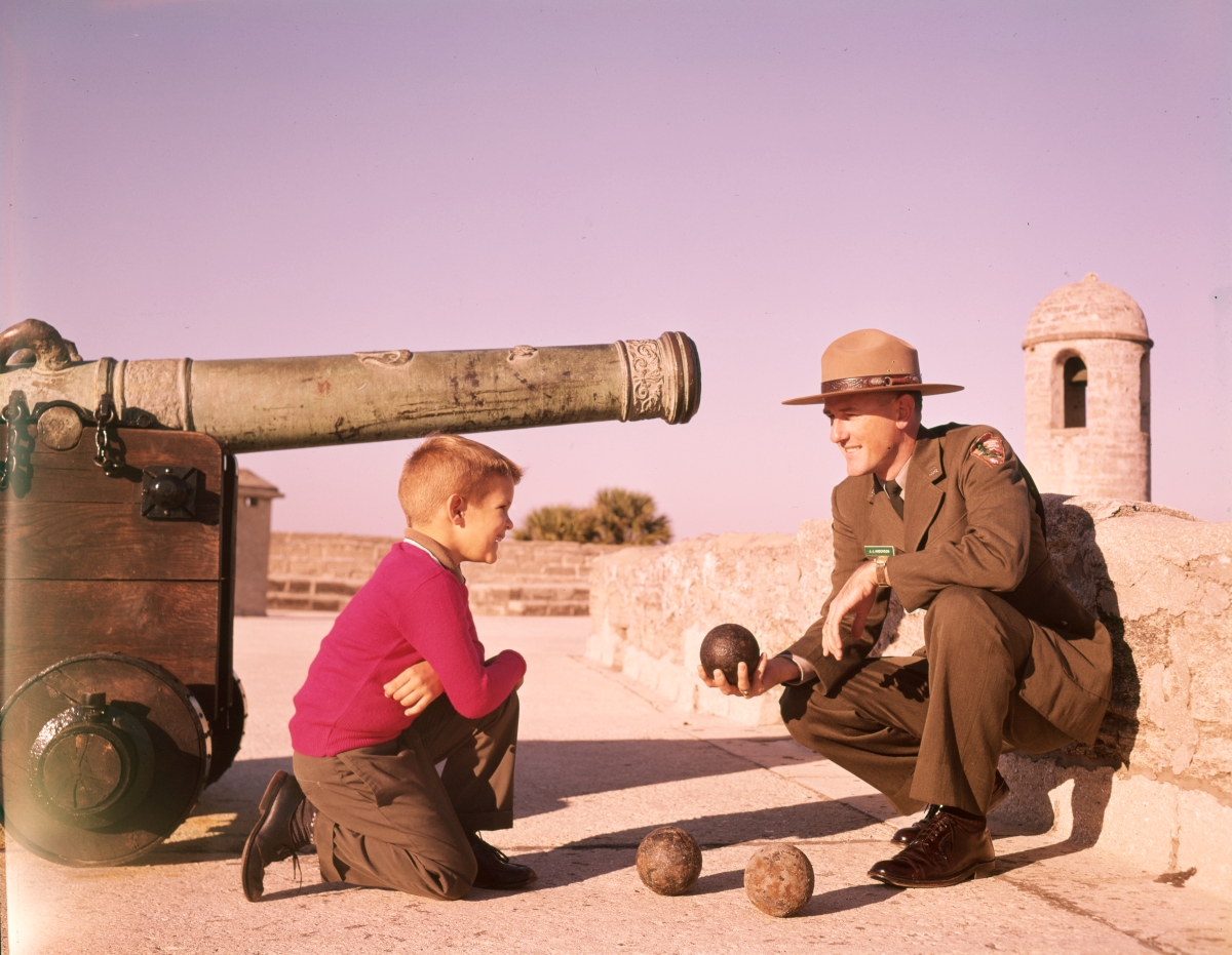Young visitor listening to ranger J.J. Anderson describe the cannon at Castillo de San Marcos in St. Augustine.