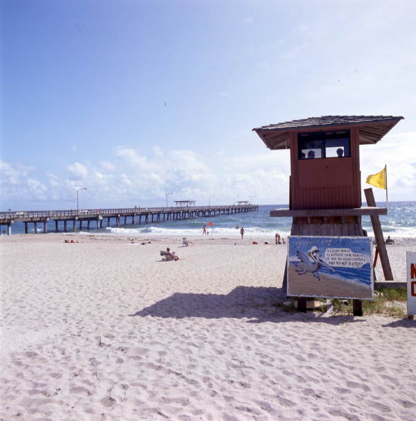 View showing pier and lifeguard station at the beach in Lake Worth, Florida.