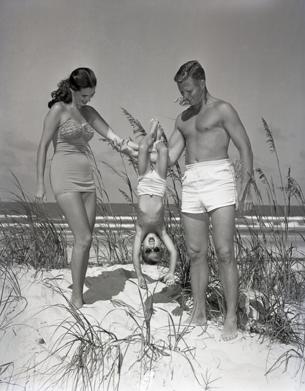 Eddie Allsopp and Eugenia Rossingnal modeling bathing suits with a boy at Daytona Beach.