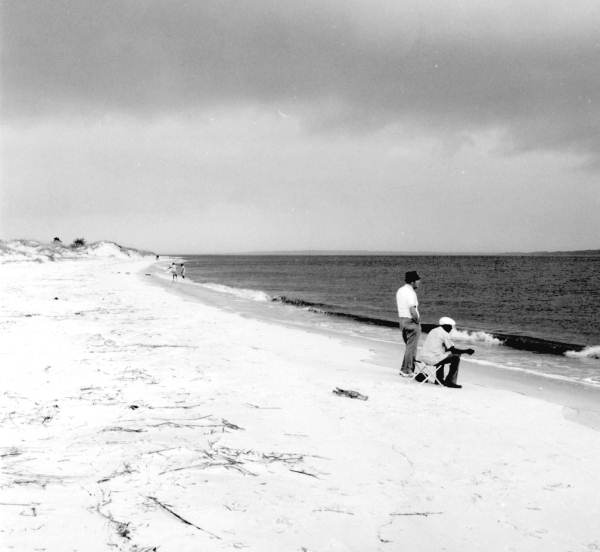 Two men look out on the water.