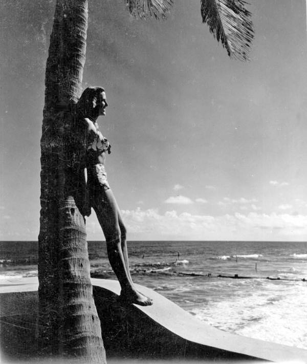 Florence Lainhart posing against a palm tree - Palm Beach, Florida.