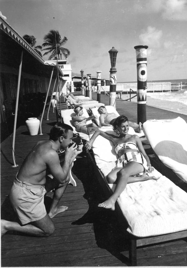 Woman poses while her husband takes a snapshot