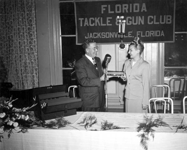Louise Dunbar McKinlay accepts fishing contest awards from Jim Murphy on behalf of California and Iowa winners - Jacksonville, Florida