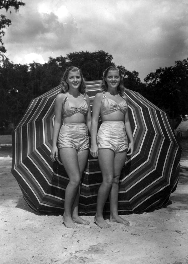Unidentified women stand on the beach area of the springs - Sanlando Springs, Florida