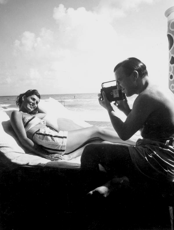 Woman poses for her husband in the sun.