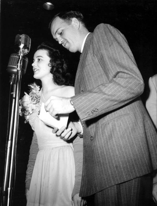 Nancy Barber, beauty contest queen, in front of microphone.