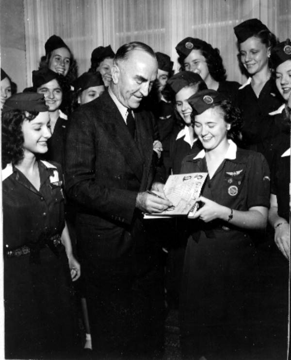 Captain Eddie Rickenbacker autographing for a girl scout