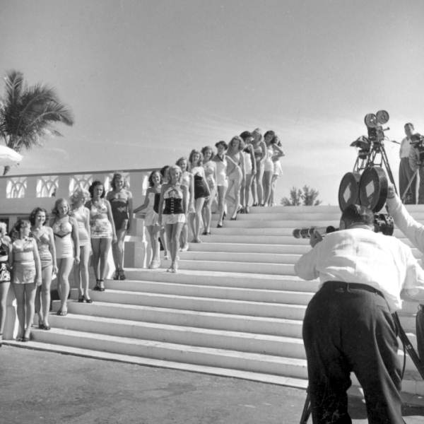 Newsreel cameramen photographing beauty contestants on pool steps at the North Shore Hotel - Miami Beach, Florida