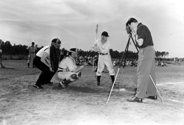 Cameraman Al Taffet making report cart movies at home plate - Bartow, Florida