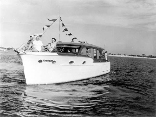 Captain Kenneth Hill of Memphis rides in his boat the "Mary K" with people on the bow
